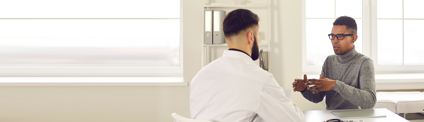 Two men discussing medical treatment.