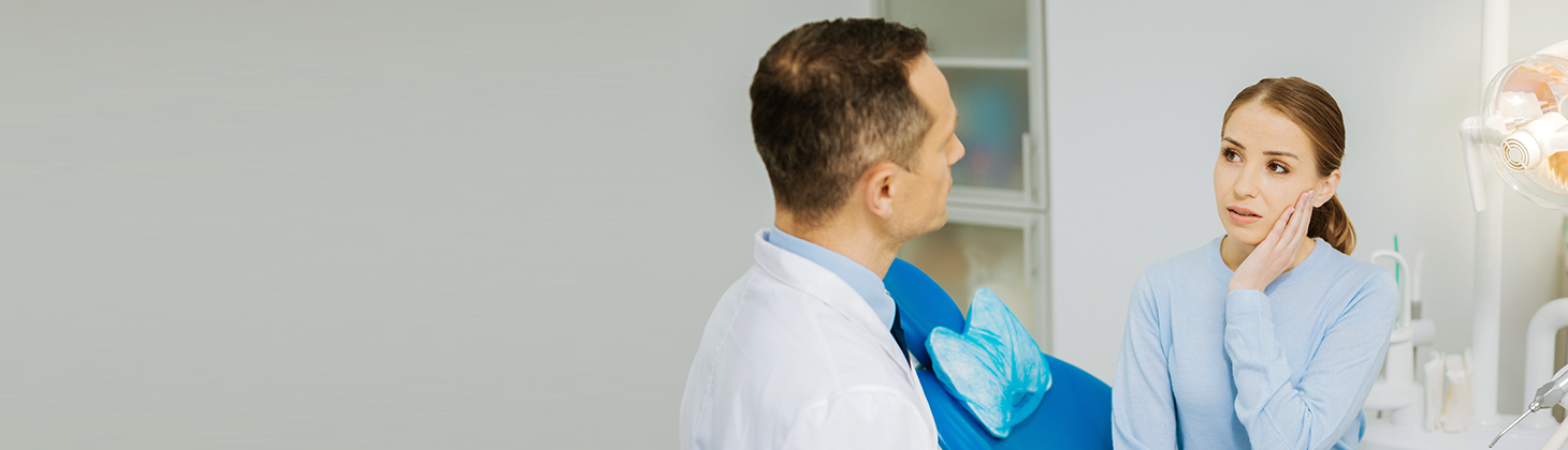 Dentist talking to female patient