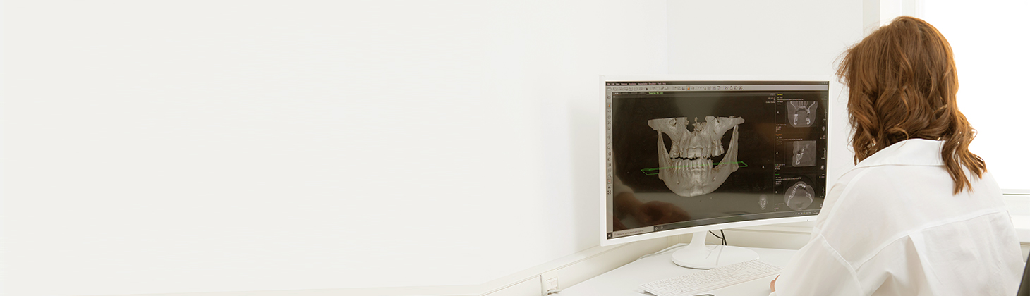 Dentist looks at an x-ray.