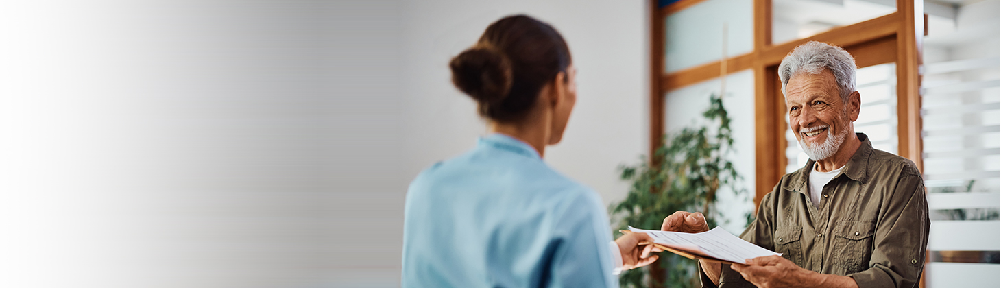 Man taking forms from doctor