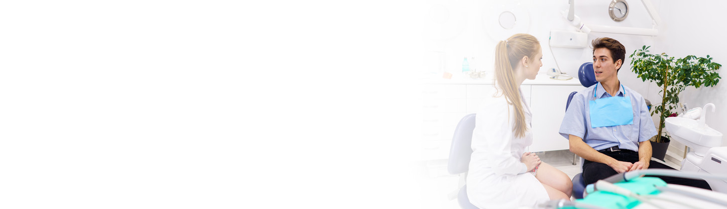 A dentist and a patient having a conversation in the dental chair.