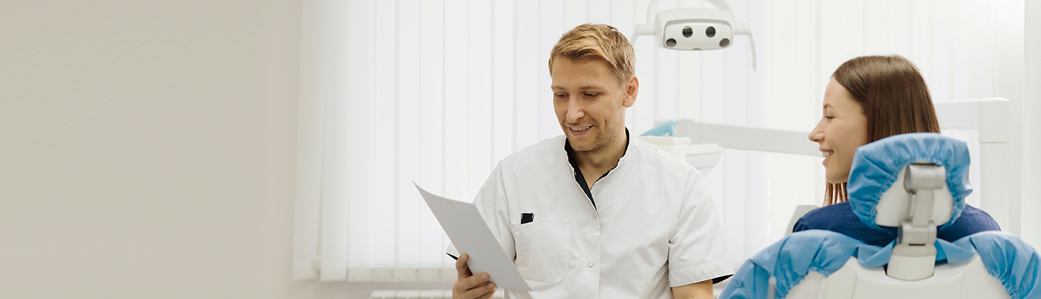 A dentist discusses referrals with a patient