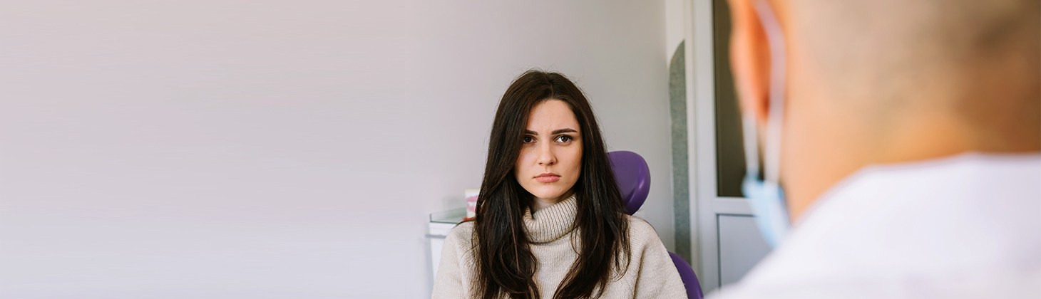 An assistant looks apprehensive about an angry patient.