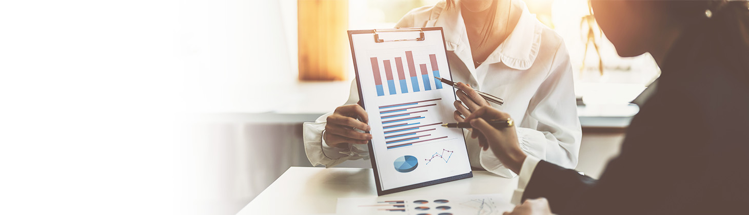 Physician looks at charts to help manage rising insurance costs.