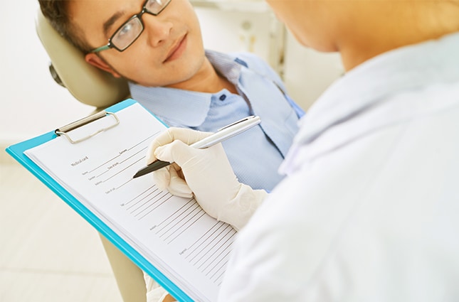 Dentist talking with patient